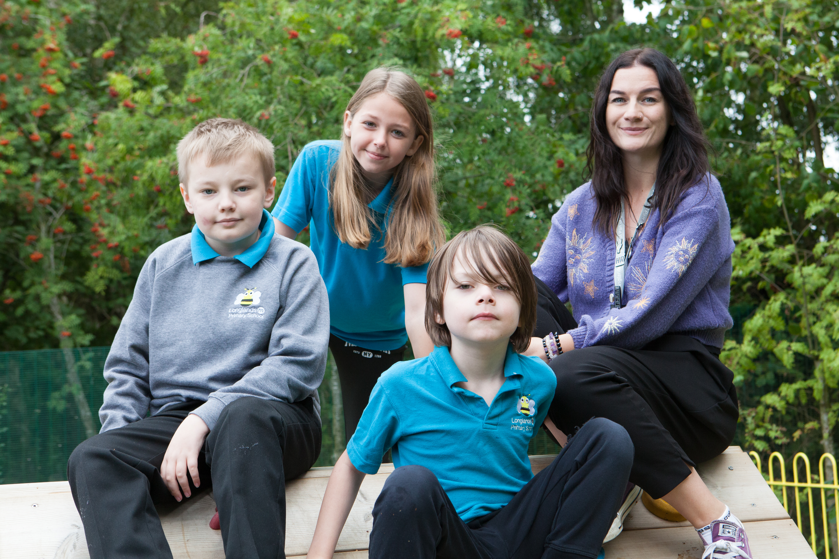 Longlands pupils with a member of staff in the school grounds.