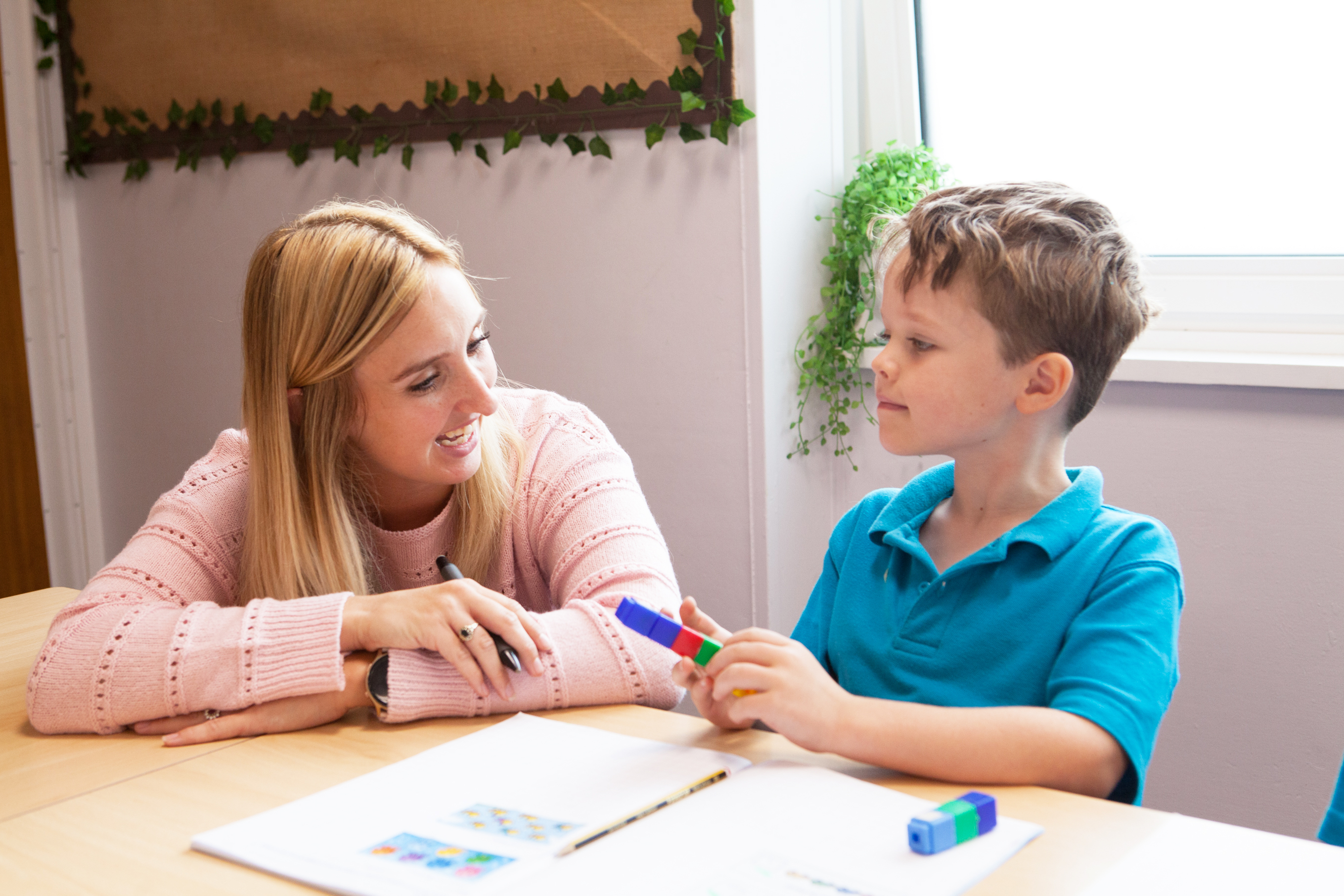 A Longlands pupil working with a member of staff in the classroom.
